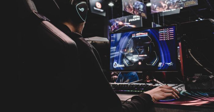 Esports player in front of computer, hand on joystick